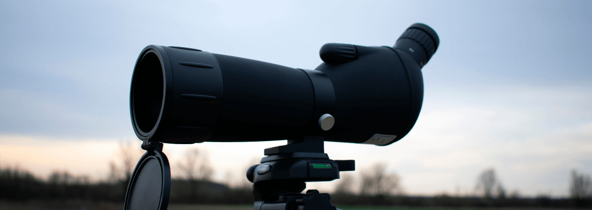 A spotting scope on a tripod during a testing session.